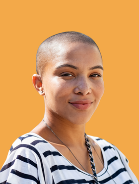 A woman in a striped shirt looks at the camera
